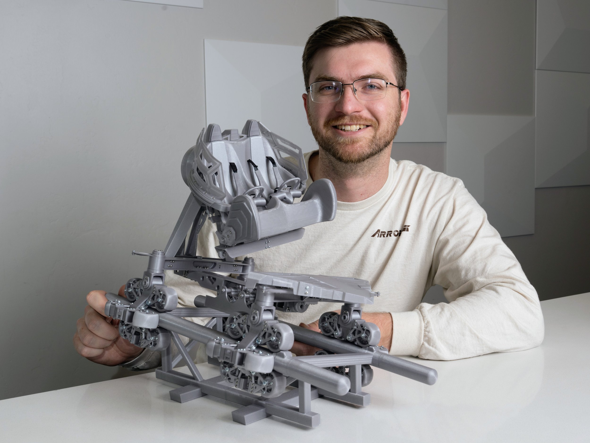 Joseph Pojunis showcasing his miniature model of the AXIS Coaster by S&S Worldwide