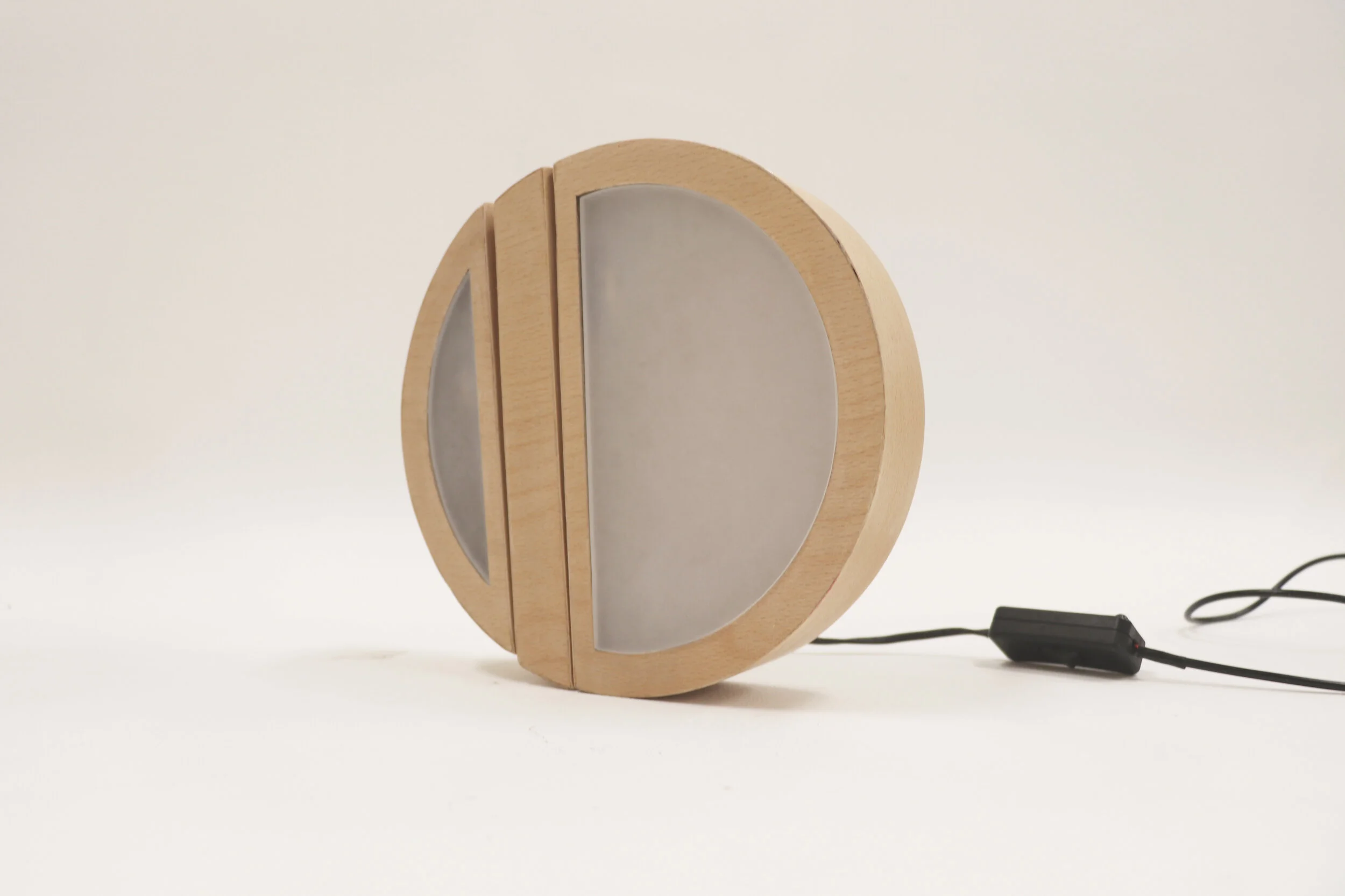 A round shape ambient lamp that is divided into two asymmetrical semi-circles. It was inspired by the philosophy of circle; the original perfection, wholeness and timelessness. The lamp has been broken into two pieces, where either side can turn aro…