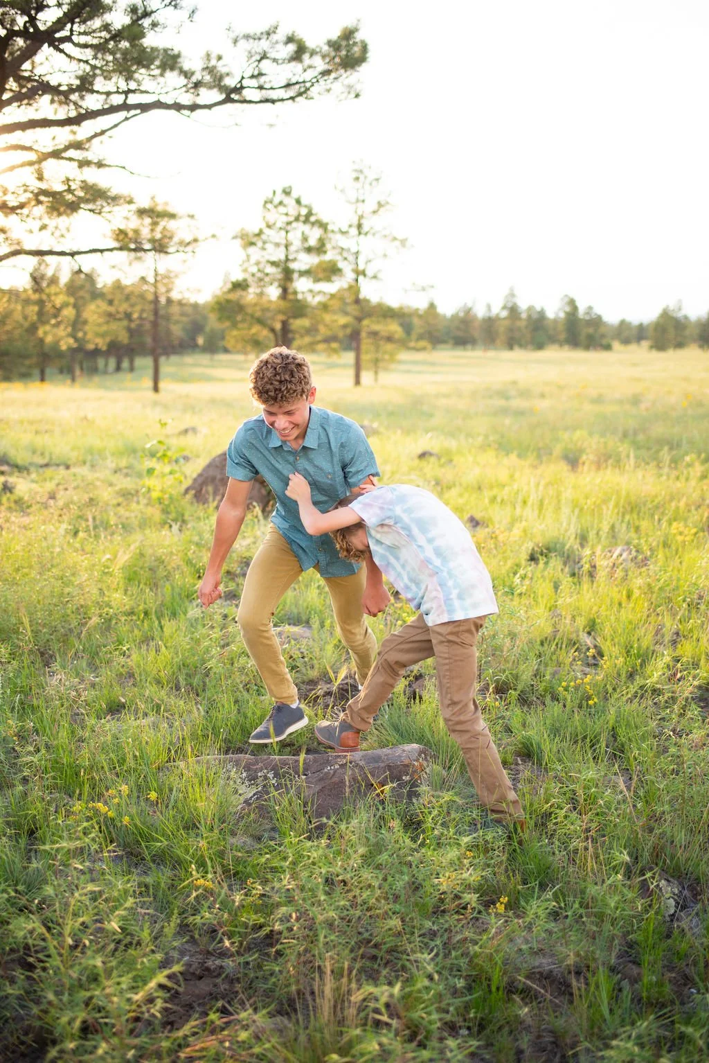 Boys play wrestling during Flagstaff family photography session