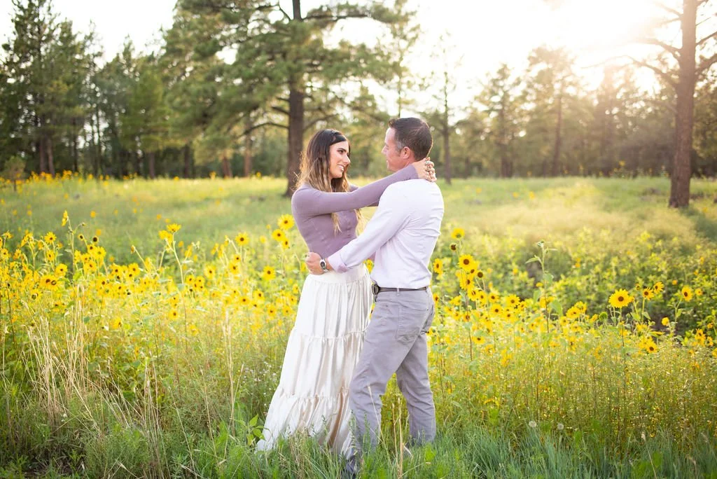 Mom and dad hugging looking into each other's eyes during Flagstaff family photoshoot