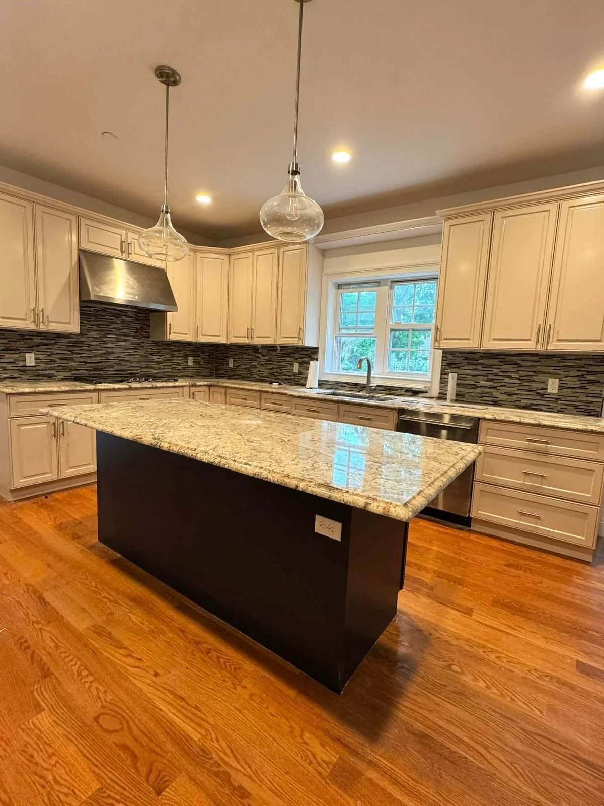 Where traditional warmth meets modern detail. Note the seamless integration of high-end appliances and expansive granite tops.