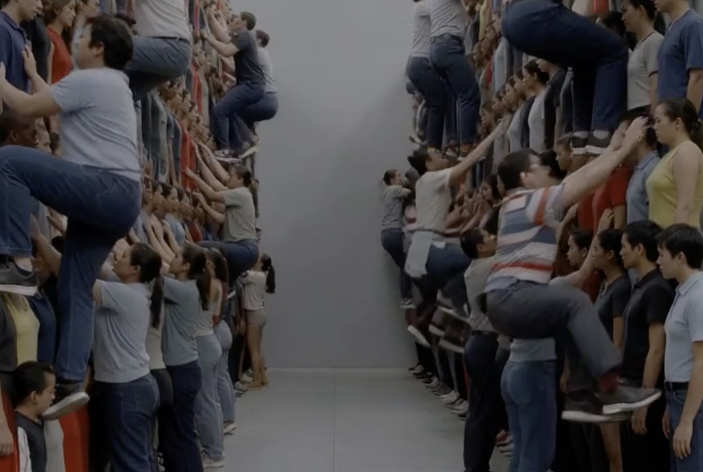 People climbing a human wall