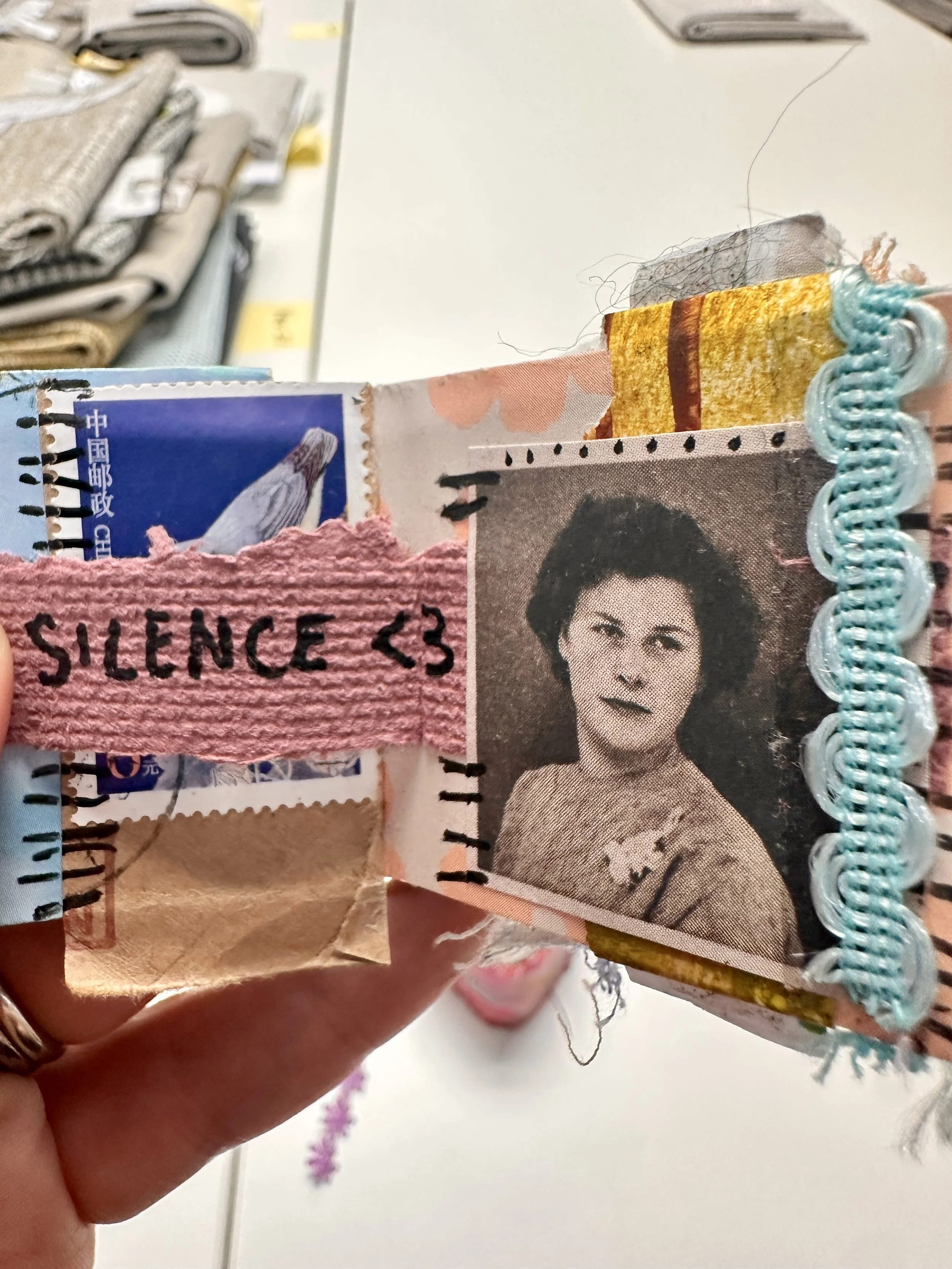 a small artbook with a black and white photo of a lady on one page and the word silence on the other.jpg