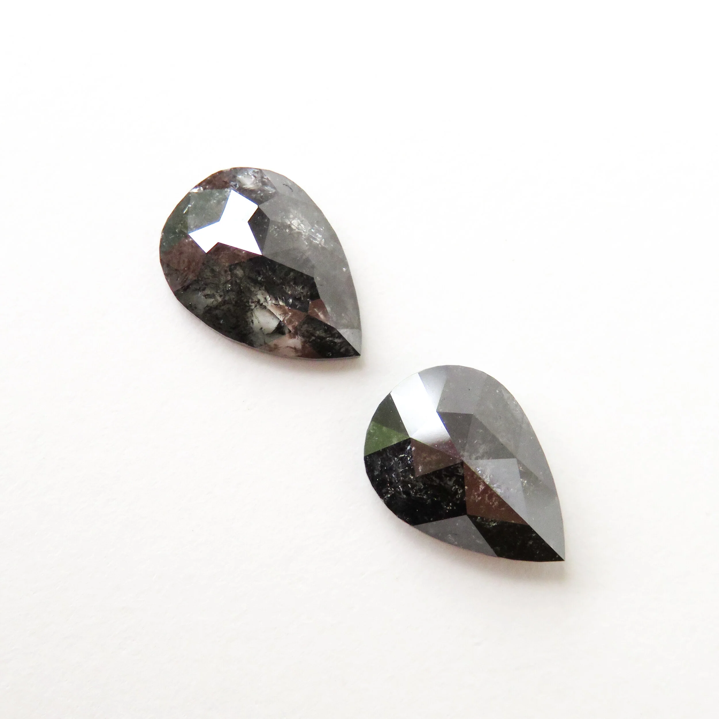 two rose cut pear shape salt and pepper diamonds