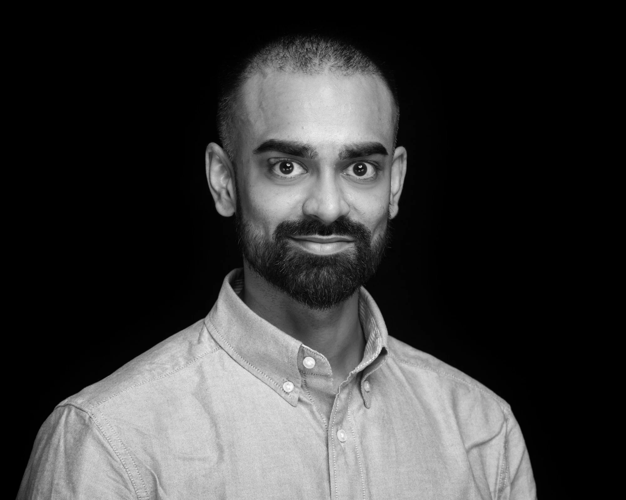 Business headshot against a black background