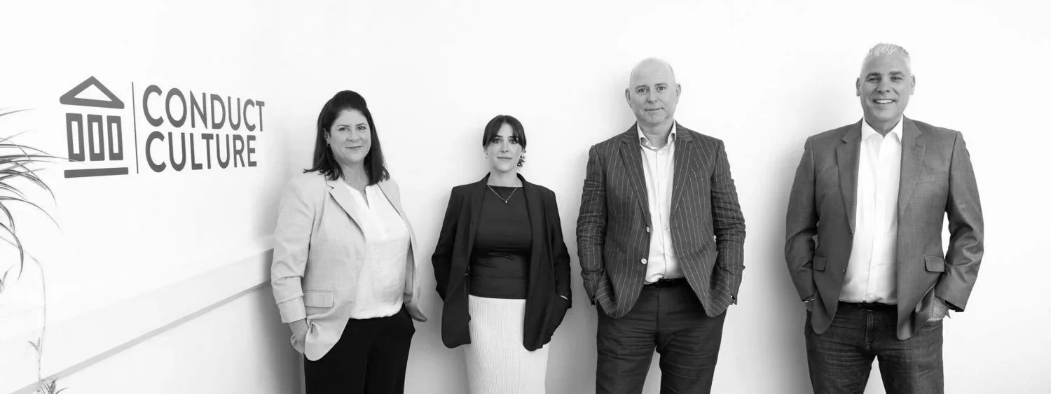 Business team against a plain wall with branding logo