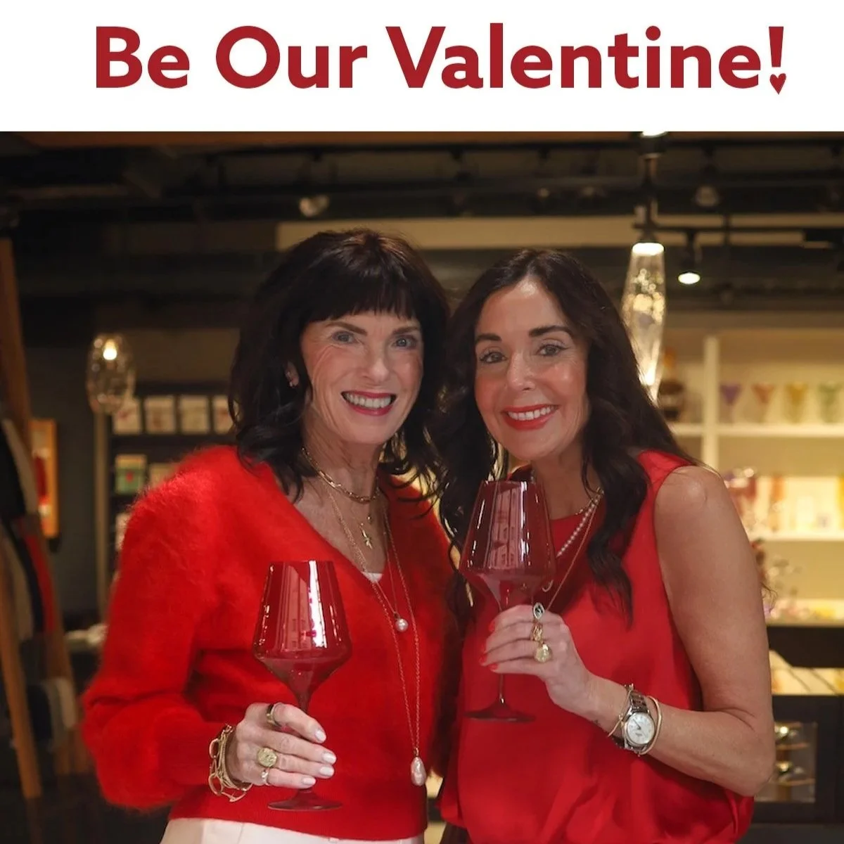 Red text saying be our valentines and two women wearing red holding champagne