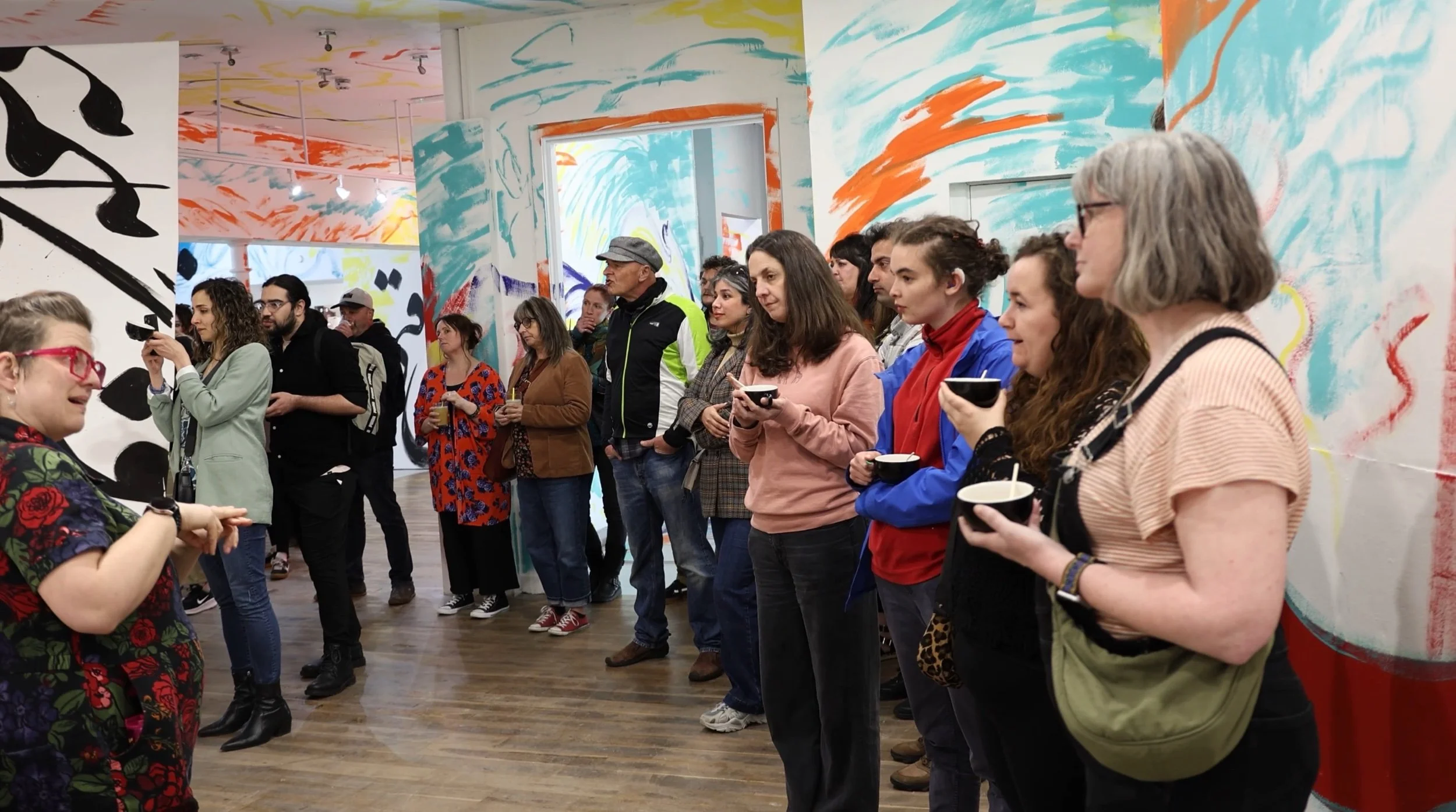 Wide view of guests at a Elysium Gallery opening event, listening to the Q+A with Sahar (out of view).jpeg