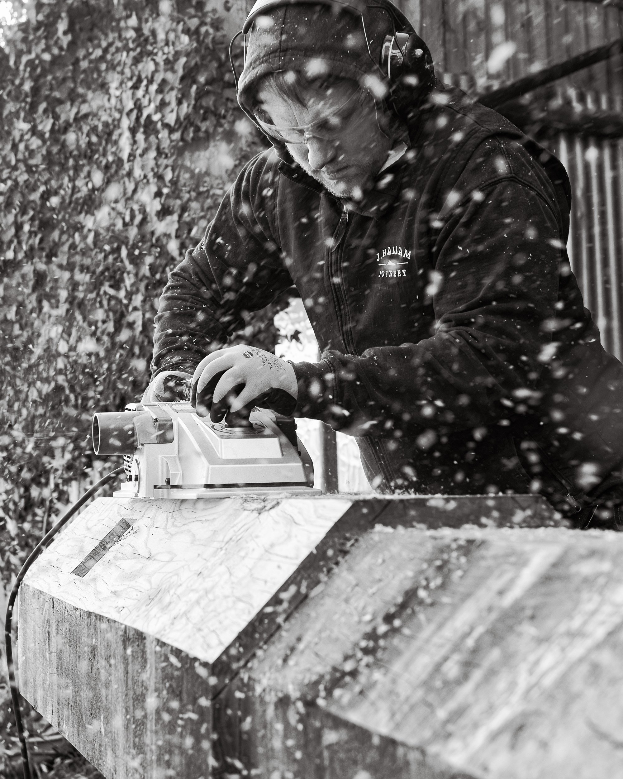 Handcrafted timber capstan being sanded by a craftsman as part of the restoration project on Whitby Harbour by J Hallam Joinery.
