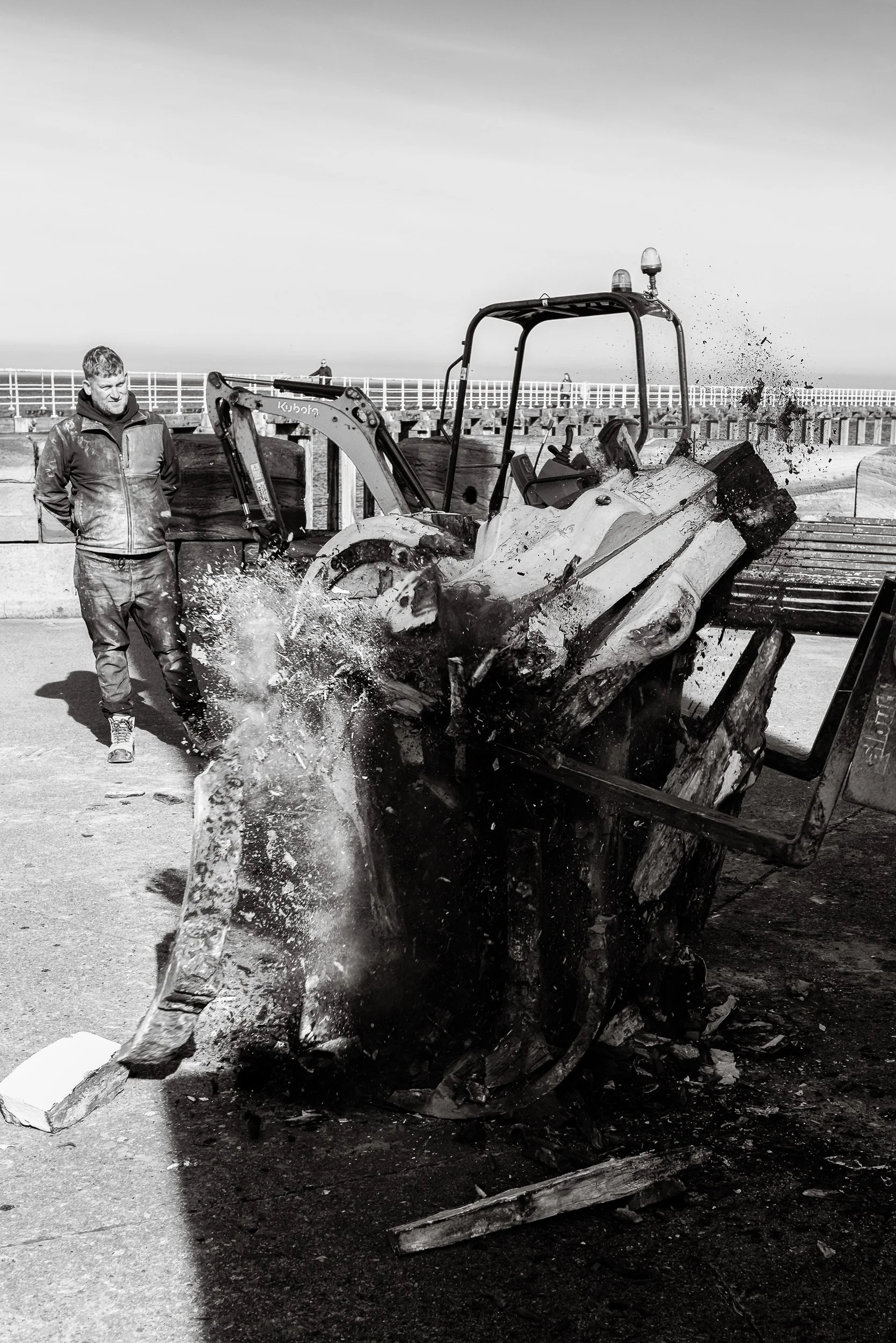 A timber capstan explodes under the force of the excavator attempting to remove it from the harbour wall as part of the heritage project to replace the capstans on Whitby Harbour.