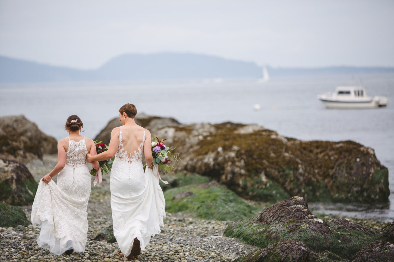 same sex couple walking on the beach by Satya Curcio Photography