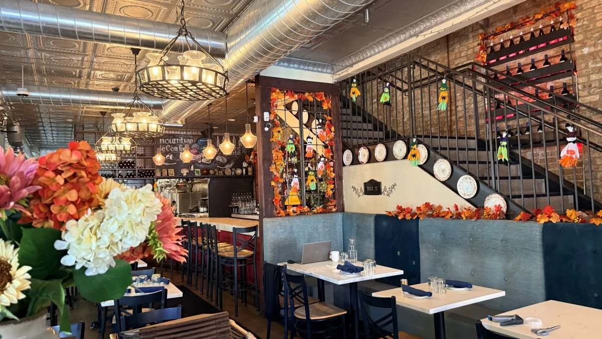Le Sud's French-Mediterranean dining room in Roscoe Village, Chicago, with fall flowers and tables set for guests