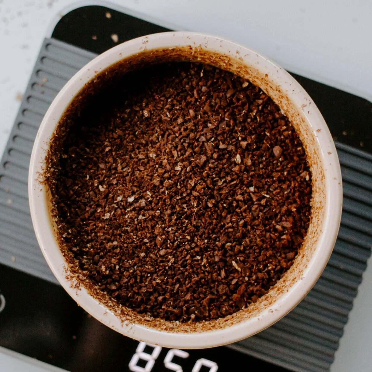 Ground coffee beans on scales
