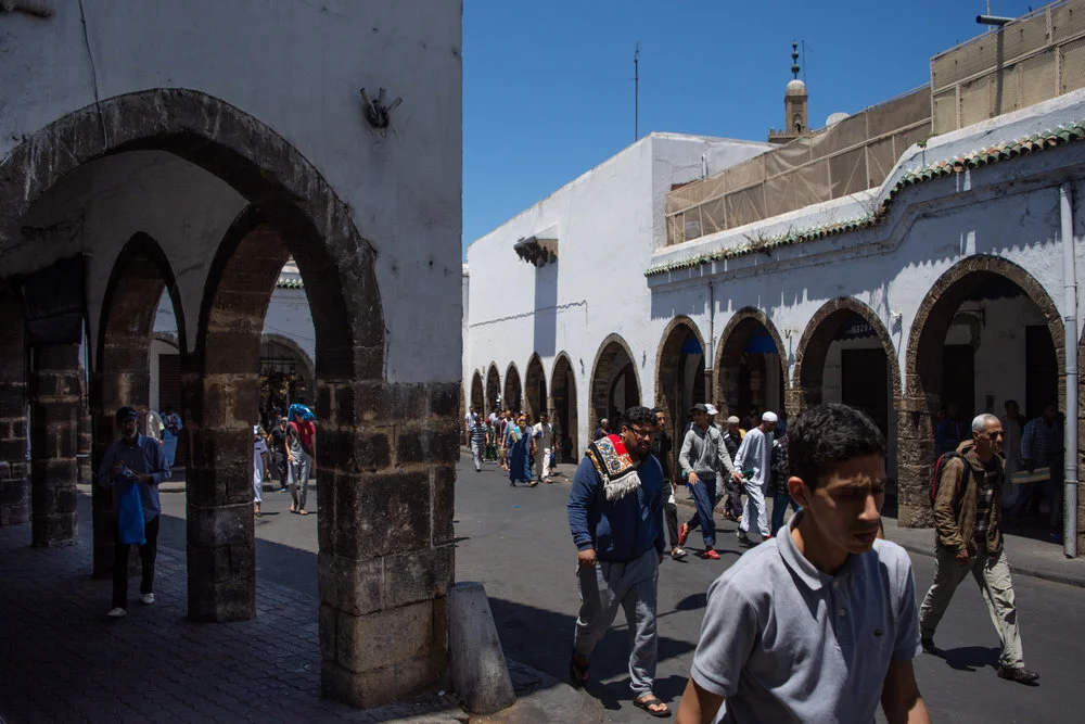 A group of local men leaving afternoon prayer to return to work