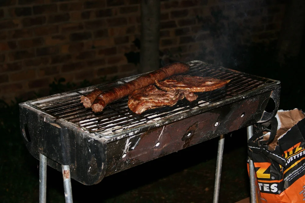 Braai is an Afrikaans word, with chesa nyama its isiZulu equivalent that describes not only the over-the-coals, direct-heat cooking method, the devices that are used to achieve it and the informal restaurants at which it’s served, but also the universally popular social event at which it usually occurs. Photo by Bothar at English Wikipedia, Public domain, via Wikimedia Commons.