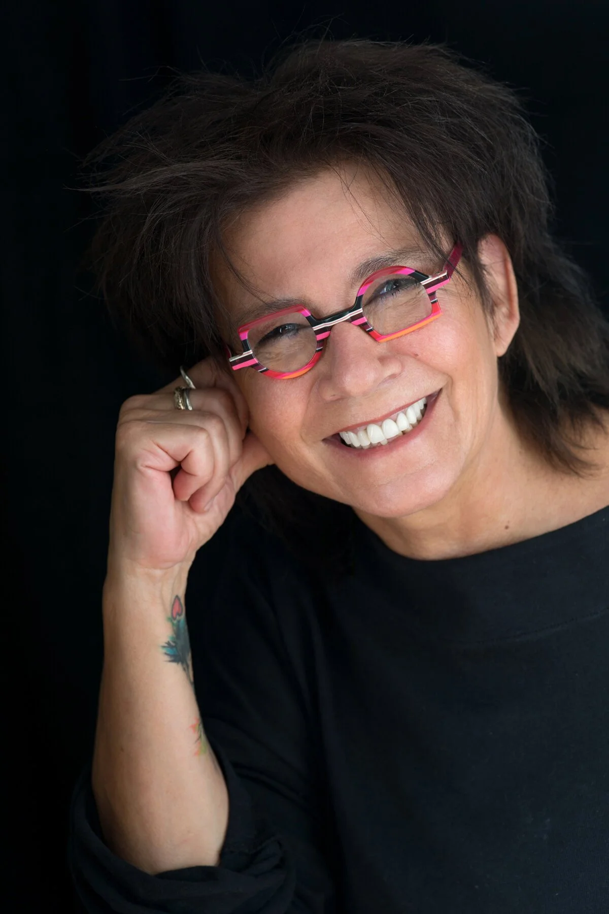 Headshot for hairstylist with the cool glasses and authentic personality