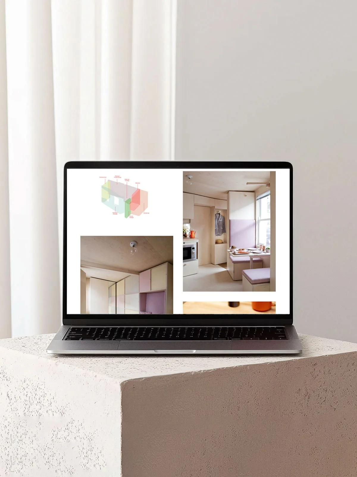 A stone plinth with a Macbook showing a Studiomama townhouse.