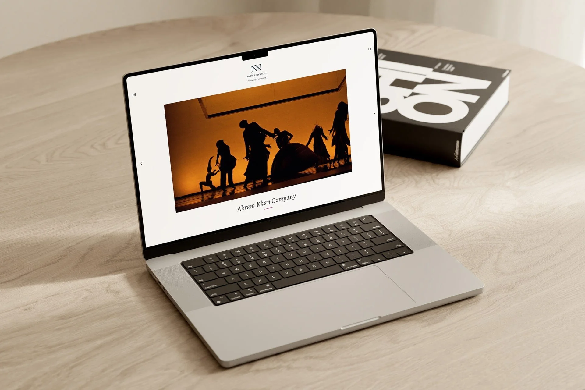 An open laptop on a table – displaying an image from an Akram Khan performance.