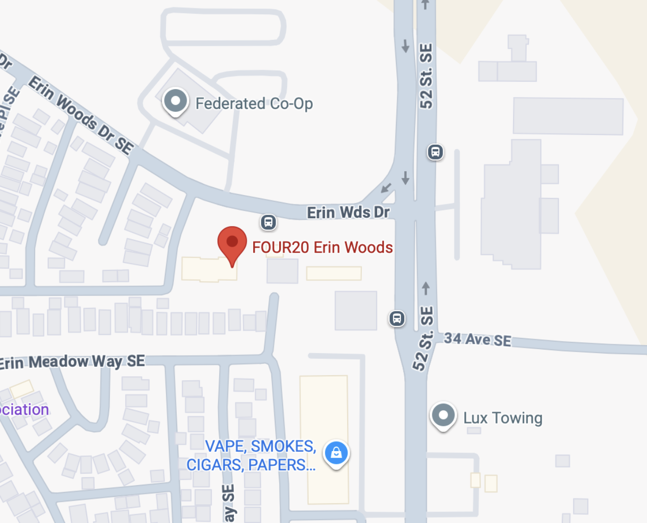 Map showing locations including FOUR20 Erin Woods, Federated Co-Op, Lux Towing, and a store selling vape, smokes, cigars, and papers, situated around Erin Wds Drive and 52nd Street SE in a residential and commercial area.