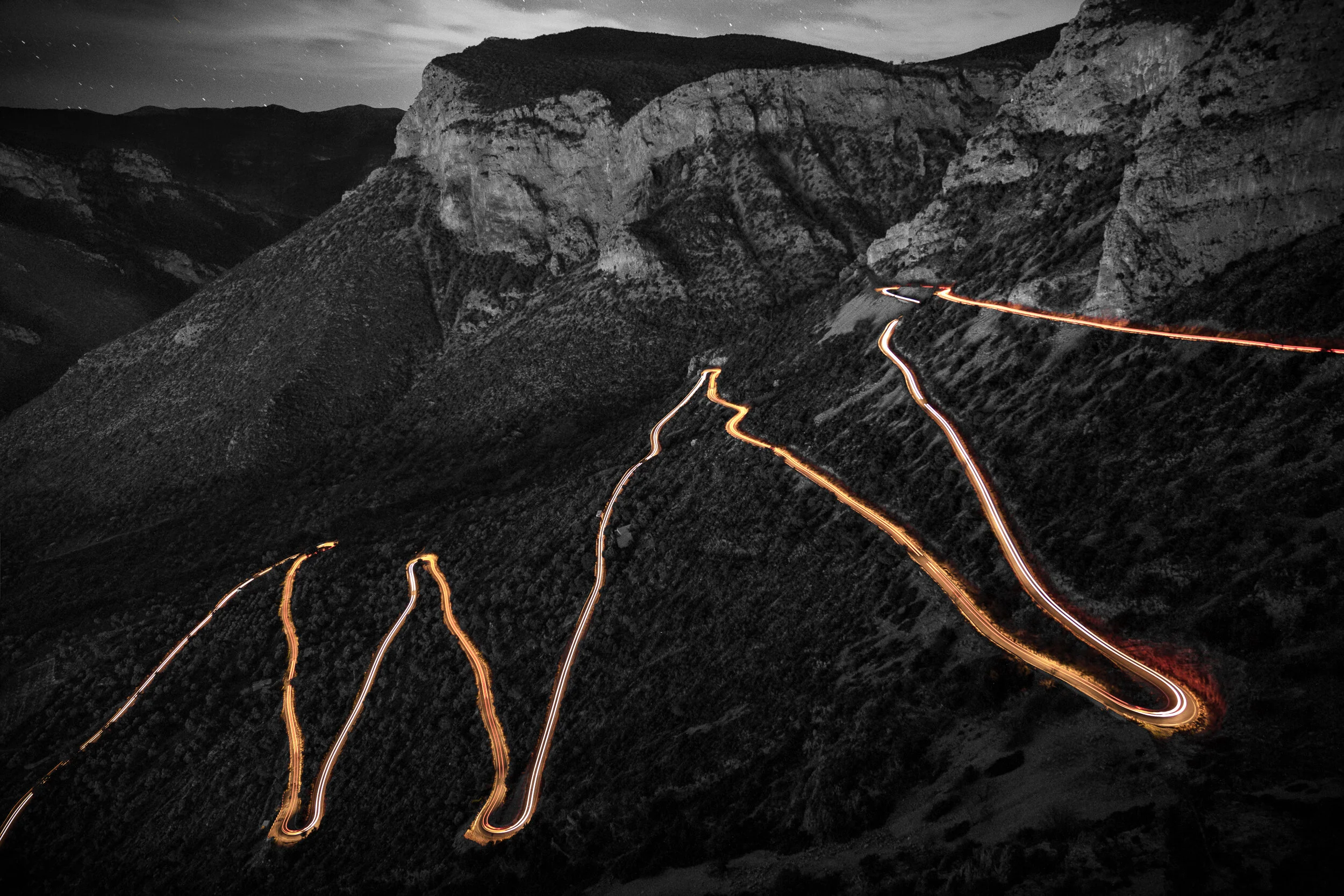 Car light trials snaking up the winding road in Leonidio.