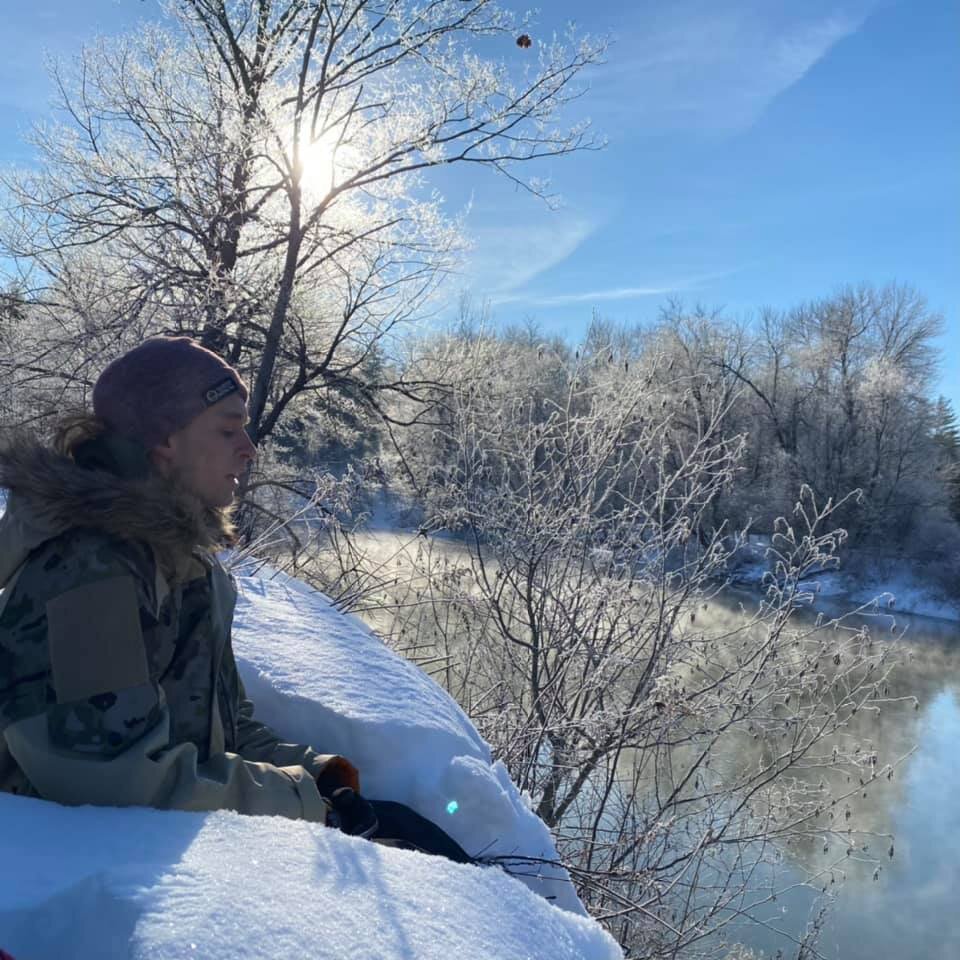 One of Maine Second Life members sitting in snow during a MSL hike.