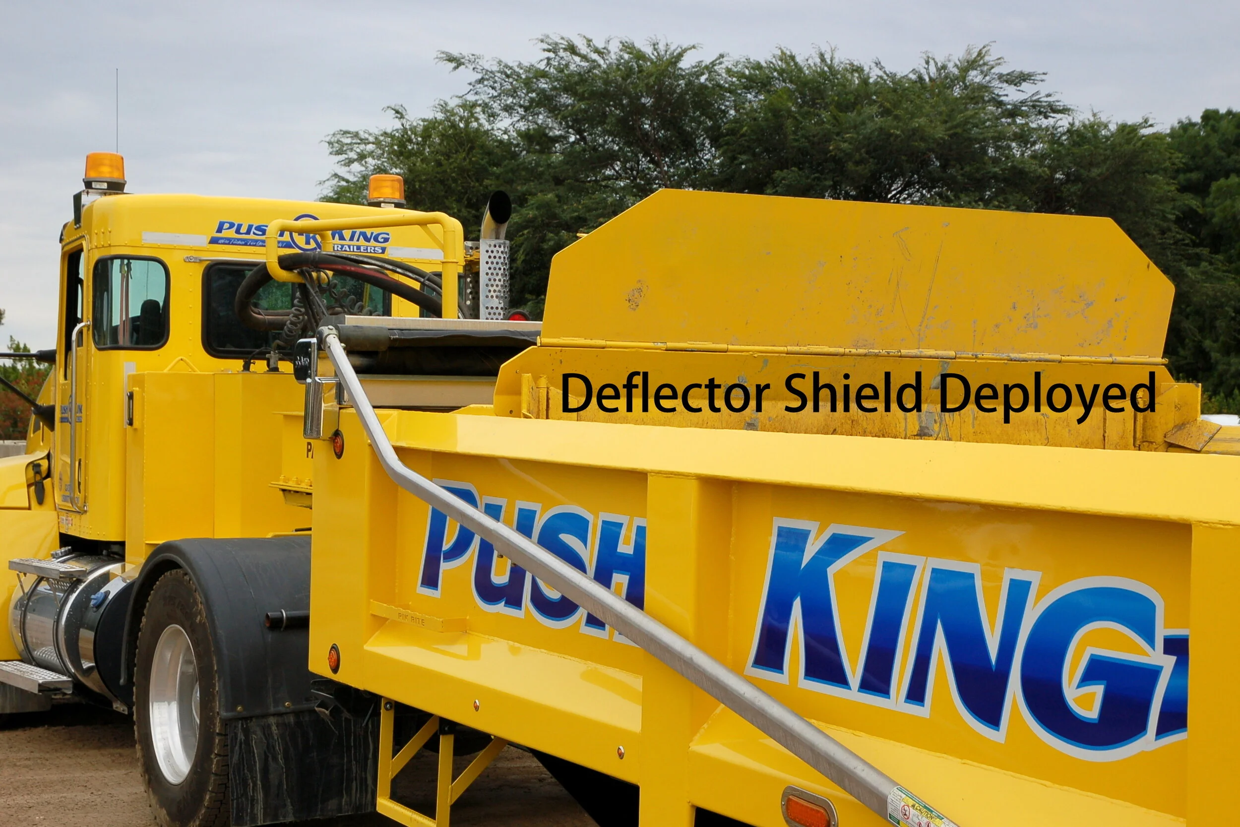 The Push King Trailer ejector has a deflector shield that automatically raises when pushing materials that tend to heave, preventing back spills.