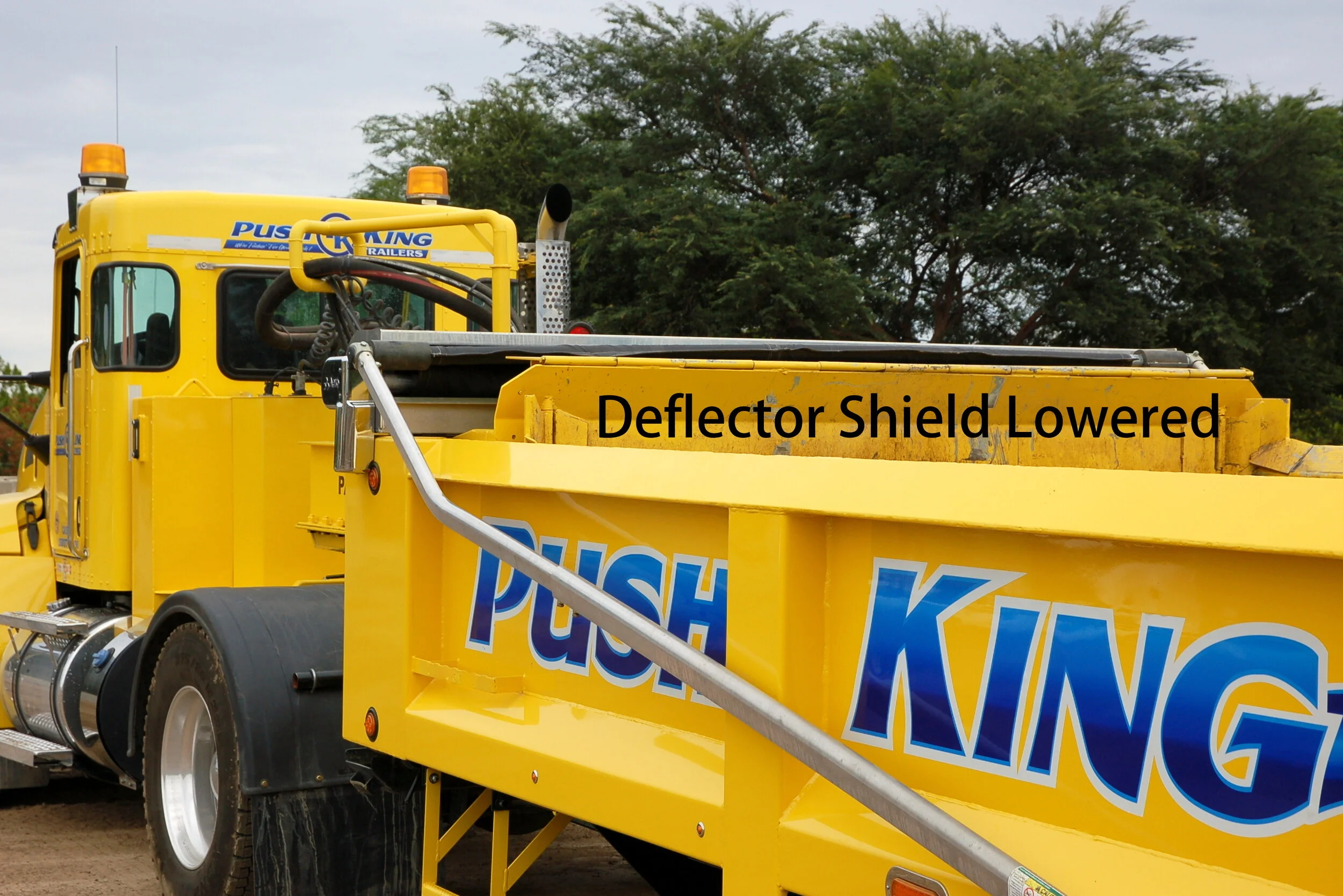 The horizontal ejector deflector shield is lowered when stowed, or when ejecting material that does not heave, allowing for optimal visibility.