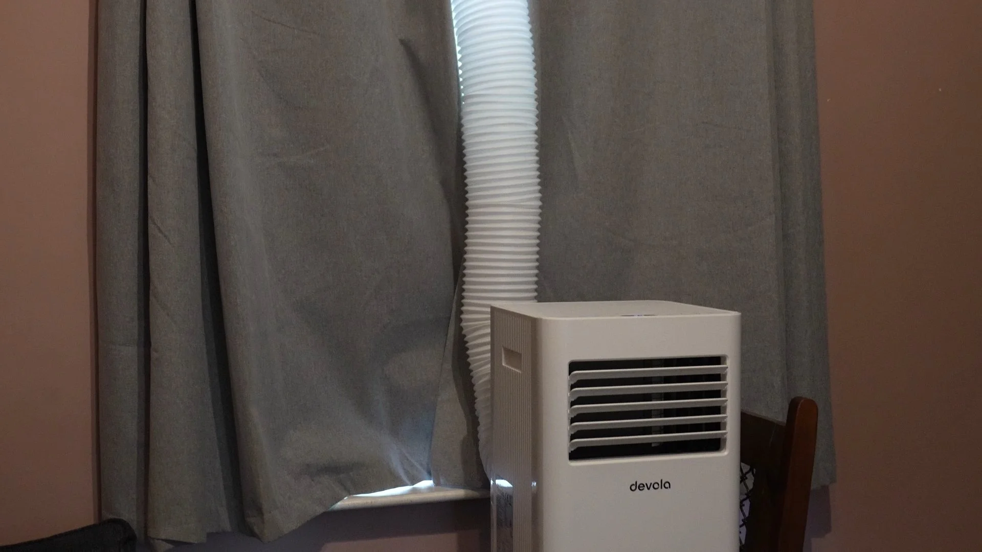 air con unit with tube out of a uk window.