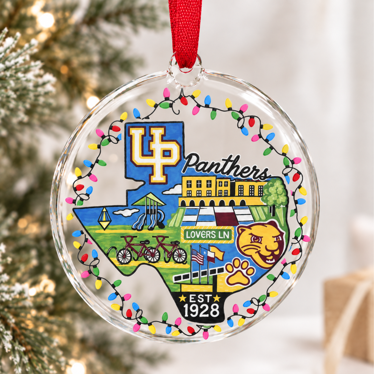 Clear glass ornament with Texas school artwork.png