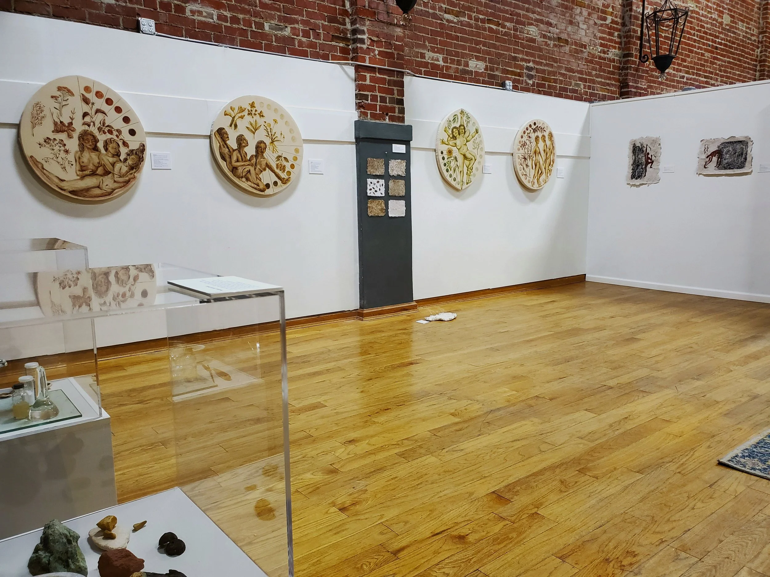 Interior view of LAC gallery showing 4 paintings along west wall, and 2 prints along the north wall