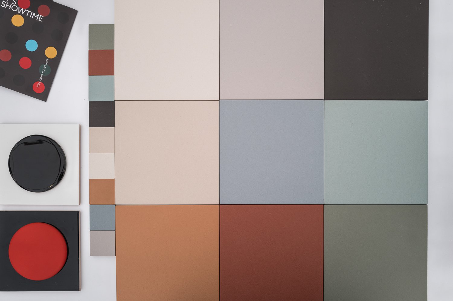 Color swatches and paint samples on a surface, with paint pots and color sample cards nearby.