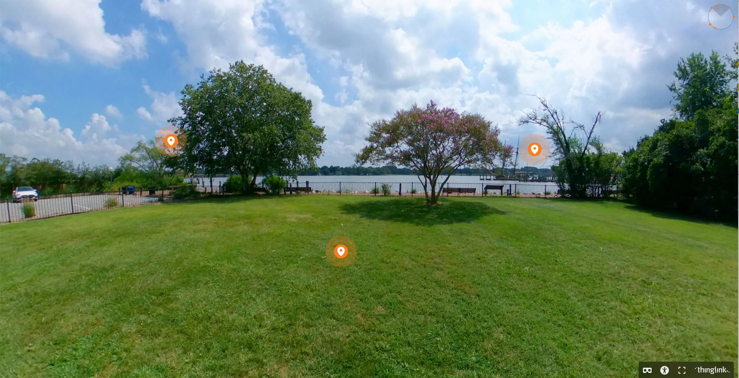 a aanoramic image of the custom house lawn trees and the chester river in the background with a sunny sky and clouds