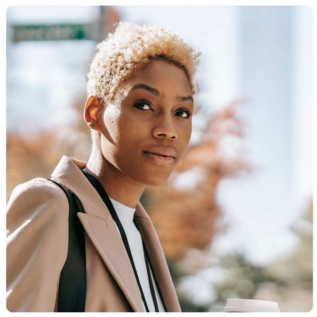 Woman without expression looks directly at camera.