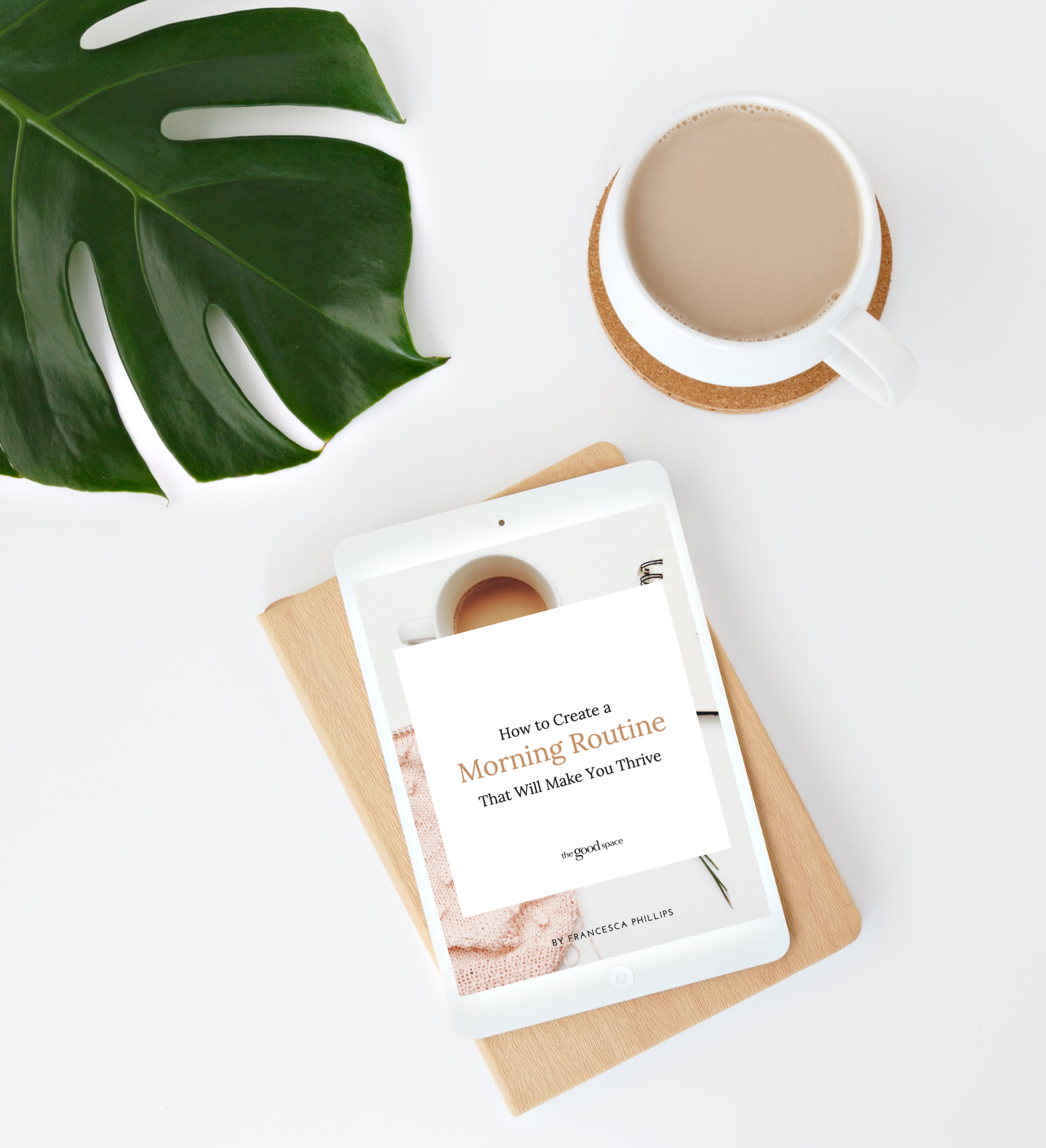A tablet displaying a digital book titled 'How to Create a Morning Routine That Will Make You Thrive' next to a cup of coffee and a green leaf on a white background.