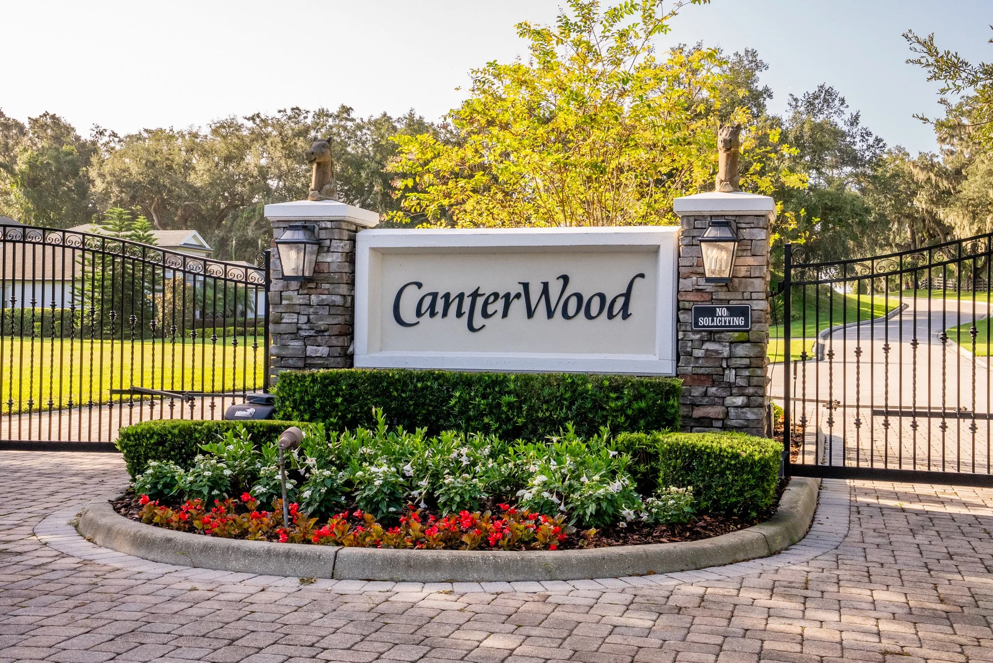 Canterwood subdivision entrance sign with shrubs, plants and flowers