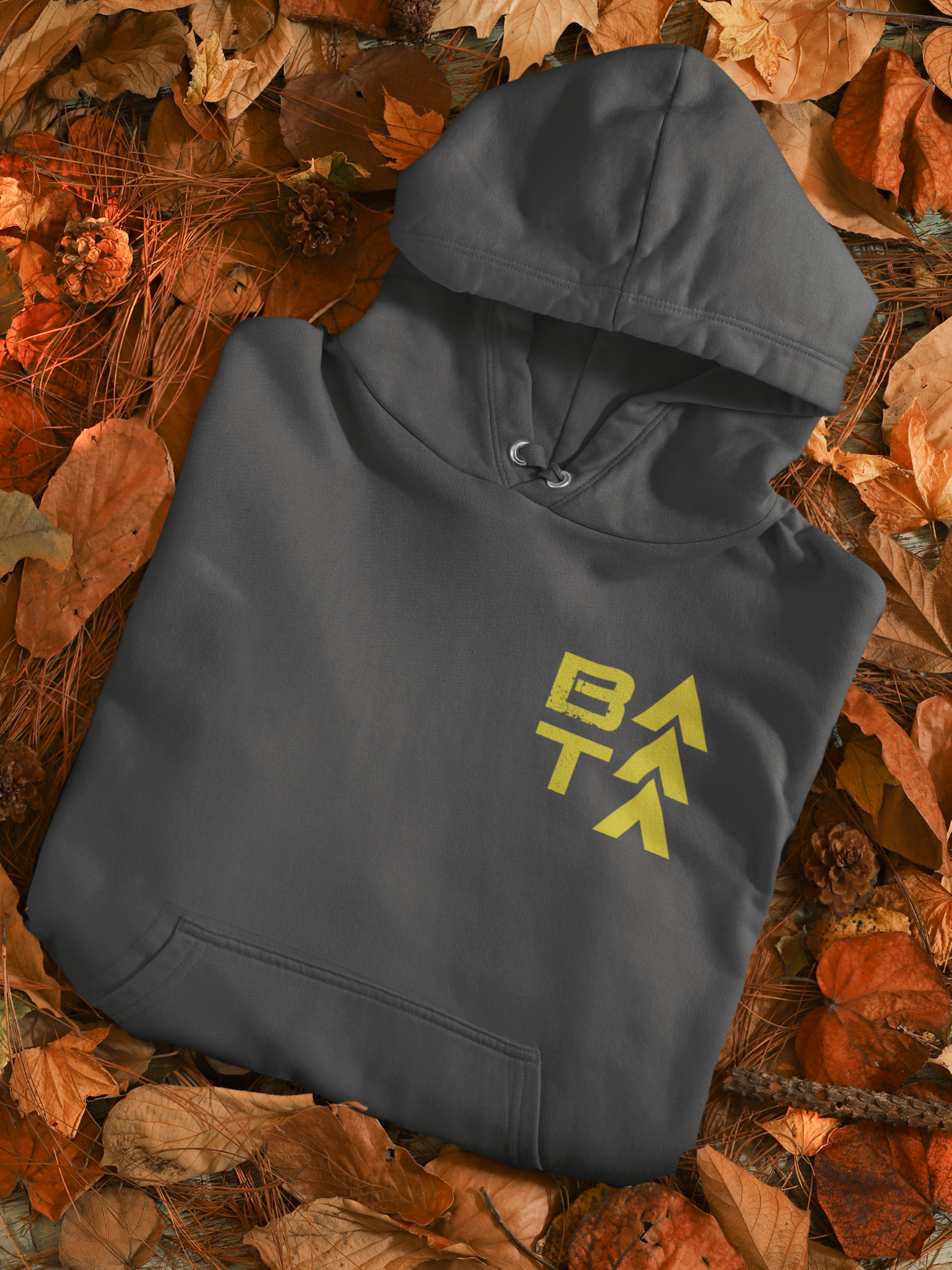 mockup-of-a-folded-pullover-hoodie-placed-over-autumn-leaves-m132.png