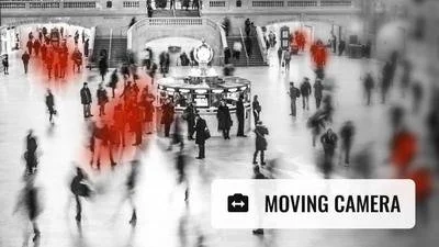 Crowd of people walking in a public space, some highlighted in red for motion blur effects.