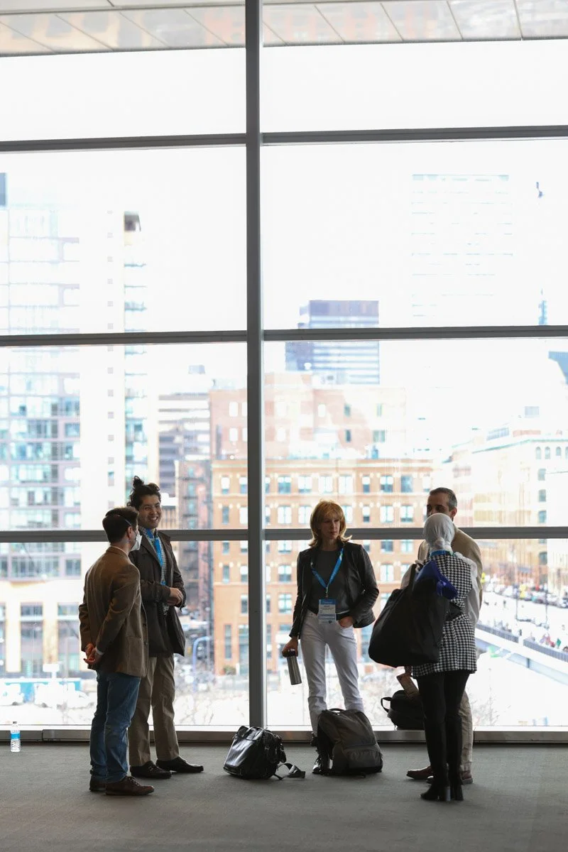 Conference attendees networking in the halls of the Boston Convention and Exhibition Center