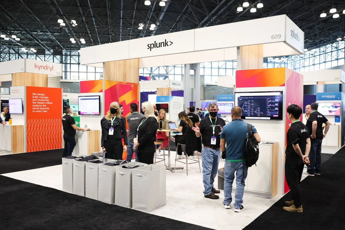 Busy corporate exhibitors showcasing technology solutions at the Amazon Web Services Summit at the Javits Center in New York City