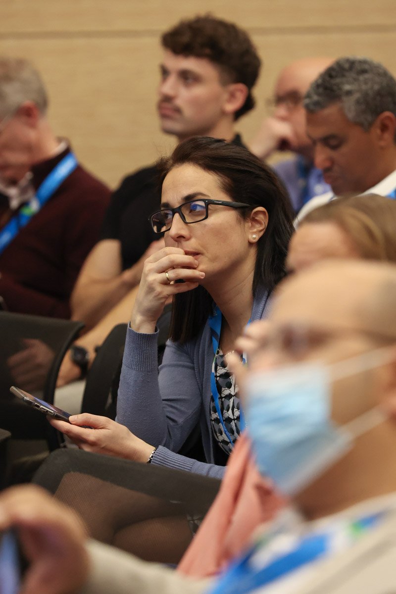 guest paying attention to the speakers at the Boston Convention and Exhibition Center