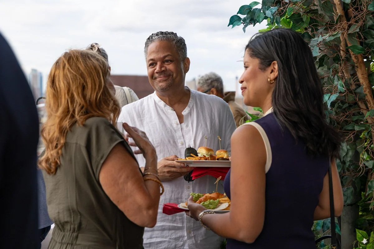 corporate executives networking in a new york city rooftop