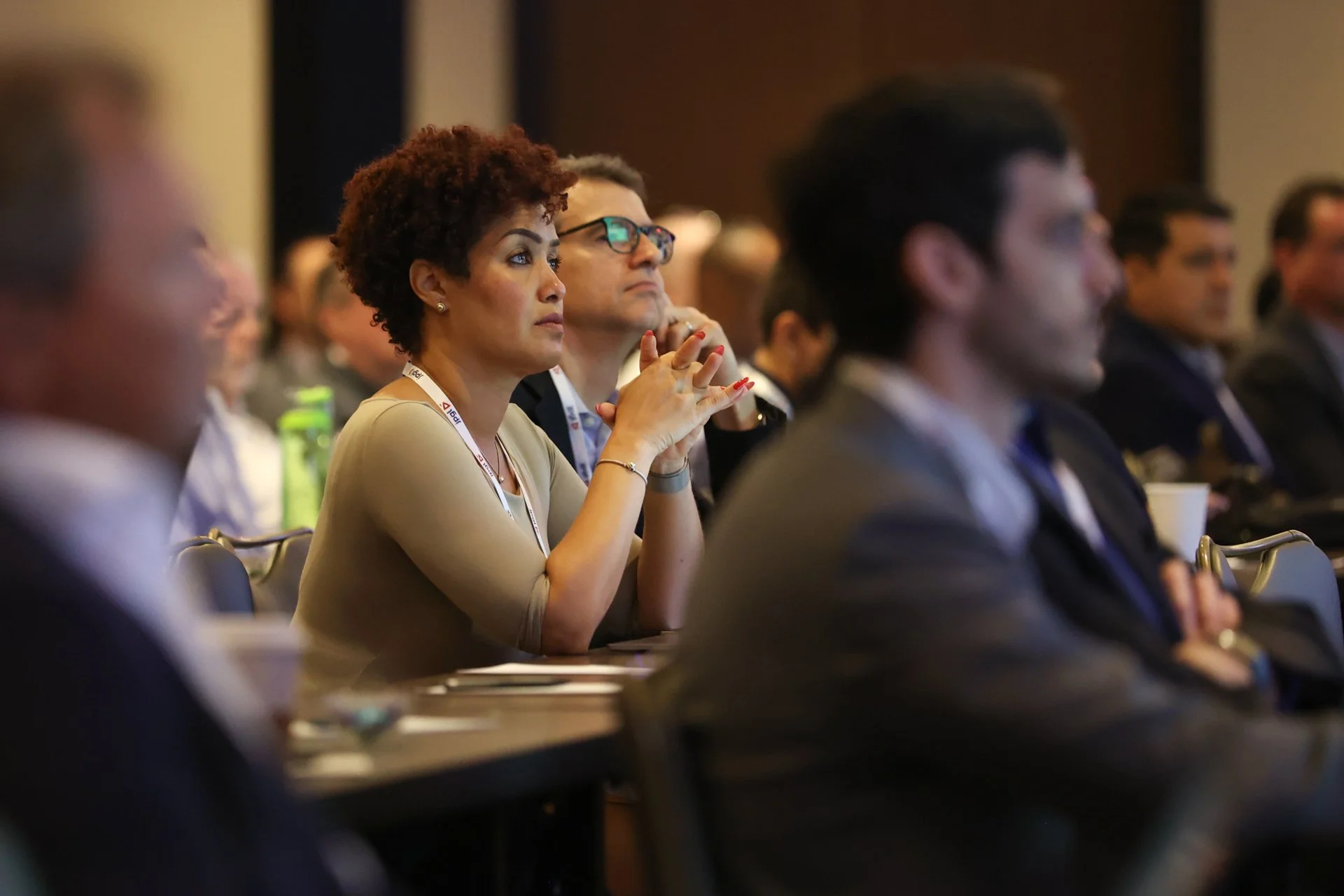 woman focusing on stage speaker