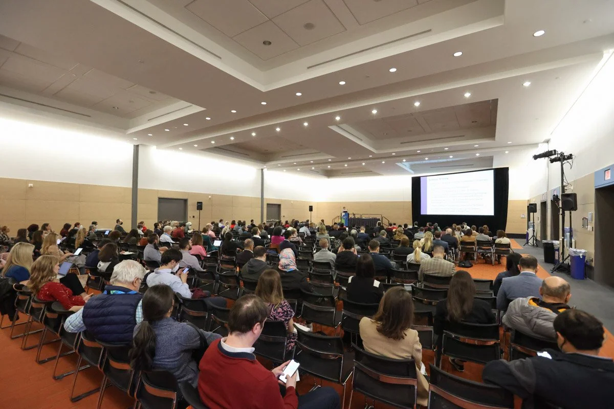 audience paying attention to the speakers at the Boston Convention and Exhibition Center