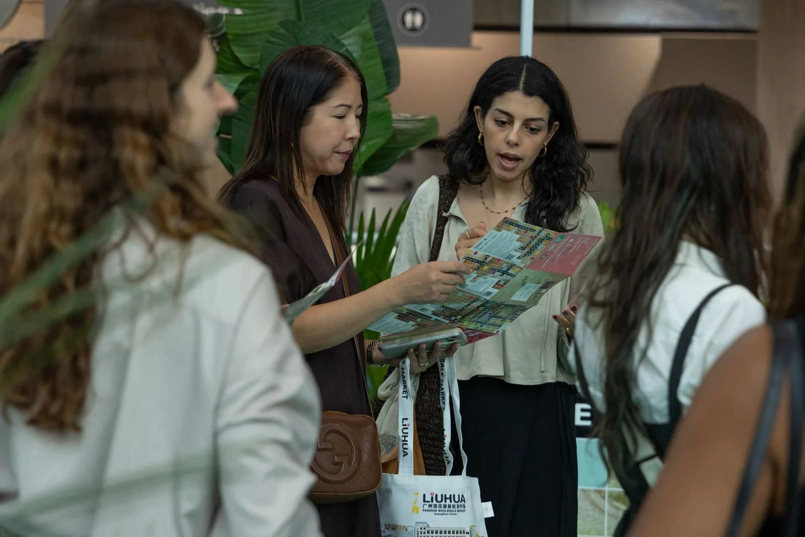 Texworld NYC attendees reading brochures at Javits Center