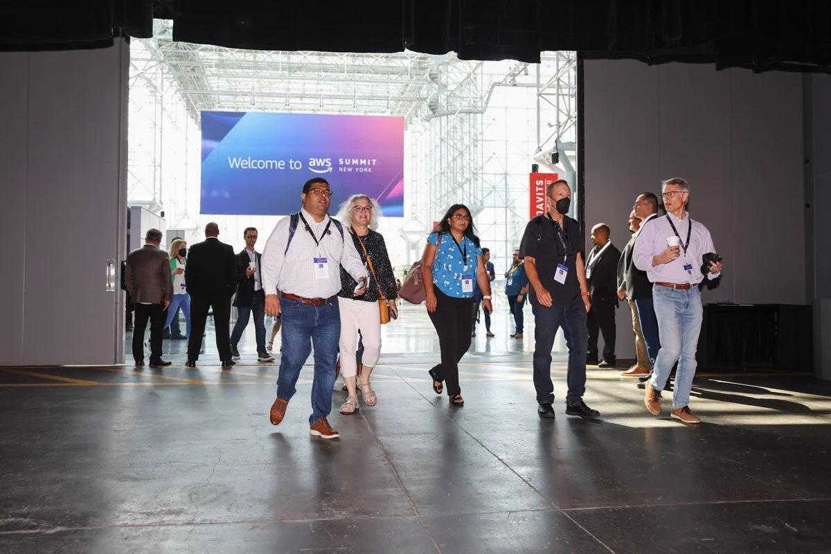 Engaged audience reacting to keynote panel discussion at the Amazon Web Services Summit conference in New York City