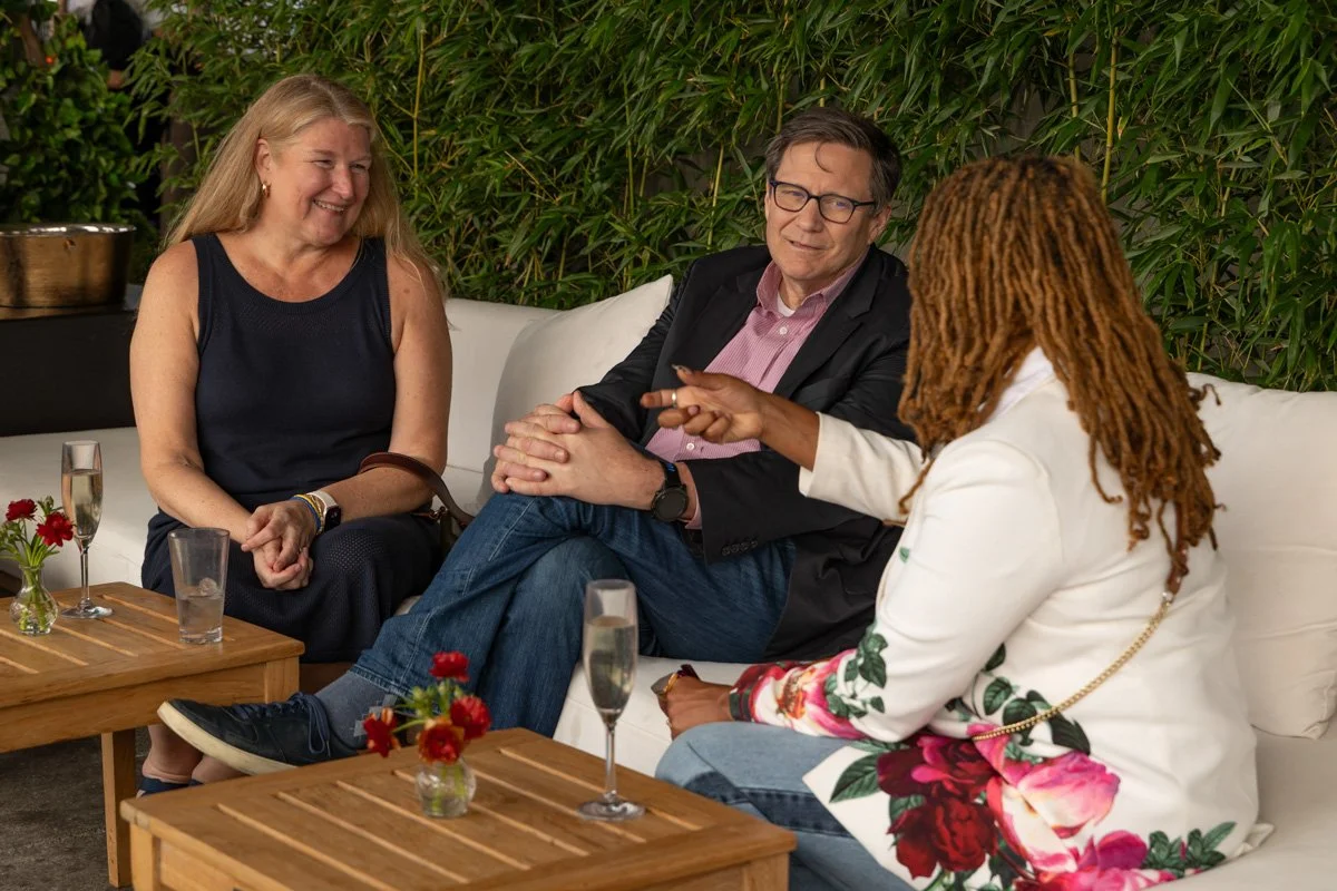 business professionals conversing at rooftop venue in nyc