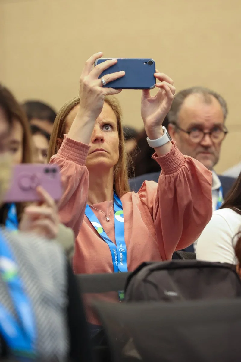 Guest taking a photo of speakers at the Boston Convention and Exhibition Center