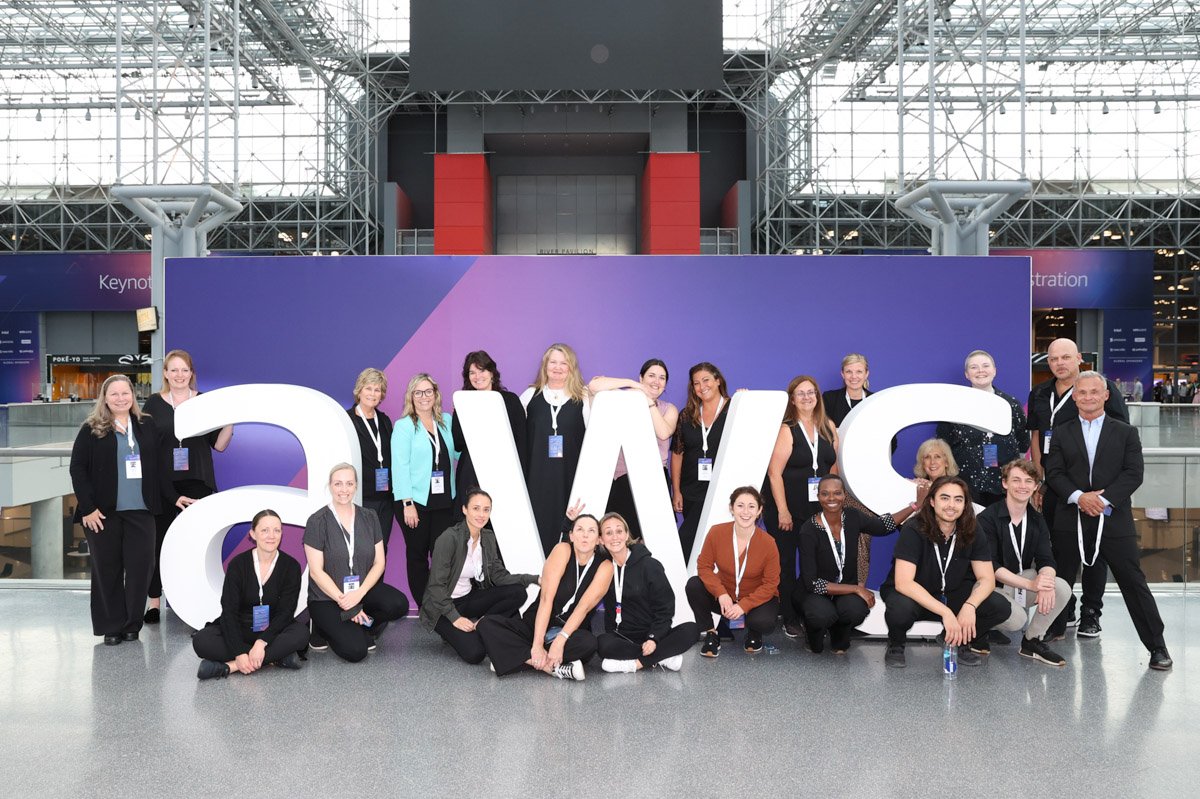 attendees posing for a photo at the Amazon Web Services Summit at the Javits Center in New York City