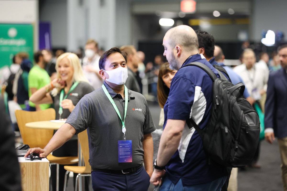 Busy corporate exhibitors showcasing technology solutions at the Amazon Web Services Summit at the Javits Center in New York City