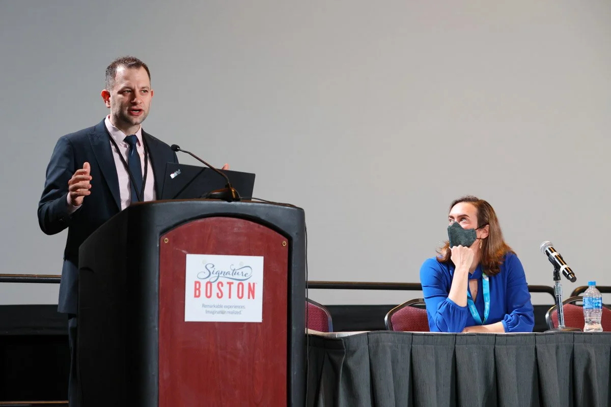 Keynote speaker presenting at a conference at the Boston Convention and Exhibition Center